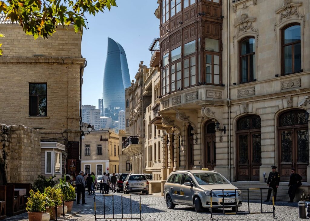 A charming street in Baku's Old City with a view of the iconic Flame Towers.